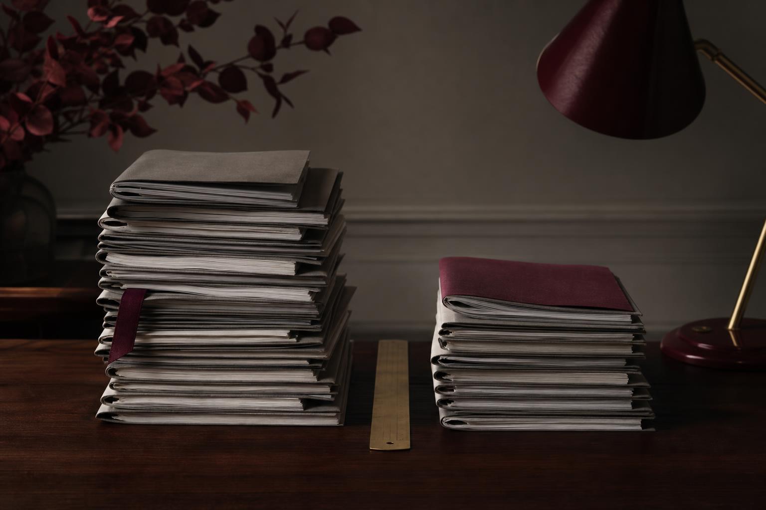 Editorial still-life comparing stacks of proposals from full-service versus specialist online reputation management companies